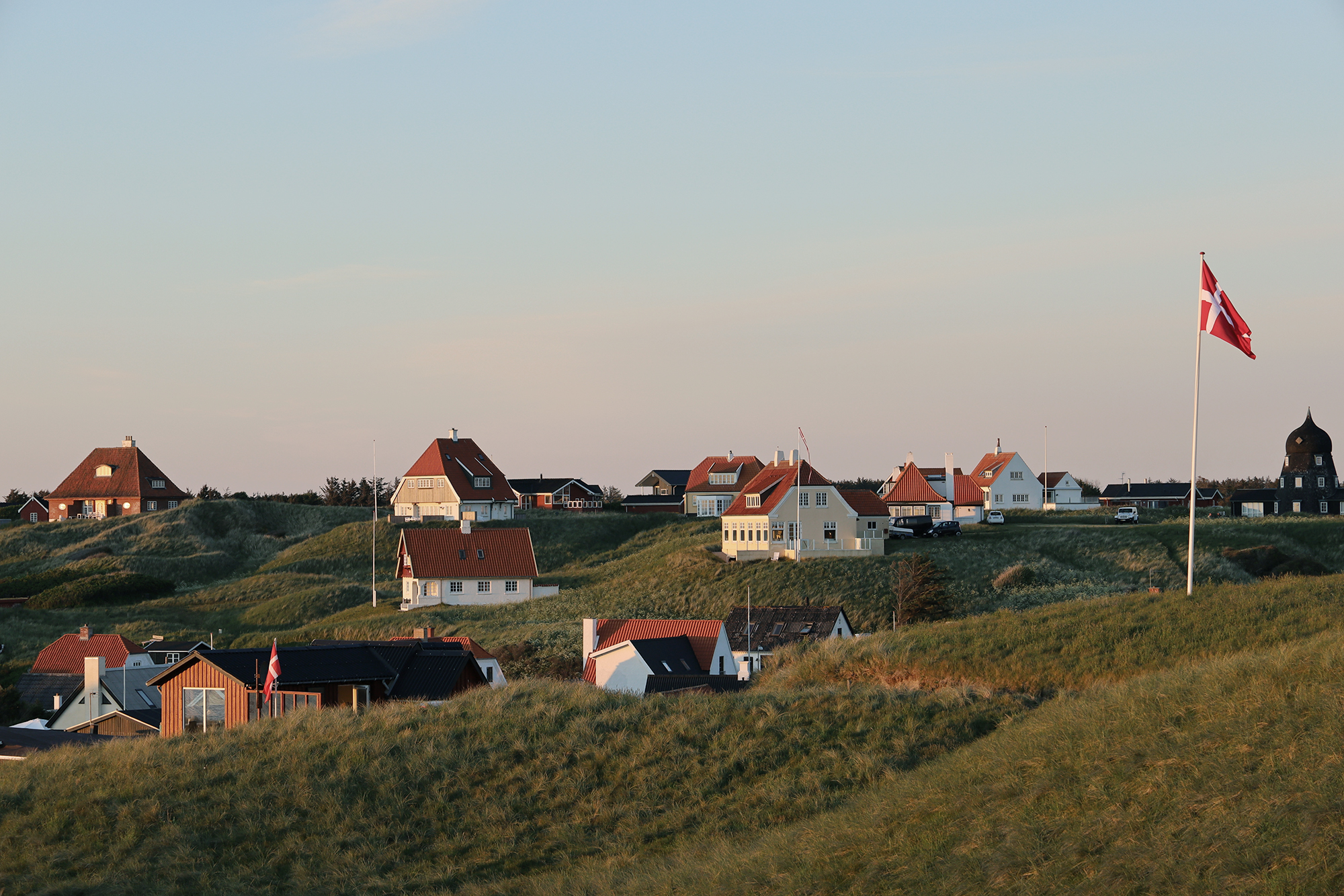 A picturesque scene of white houses on the hill in Lonstrup, Denmark